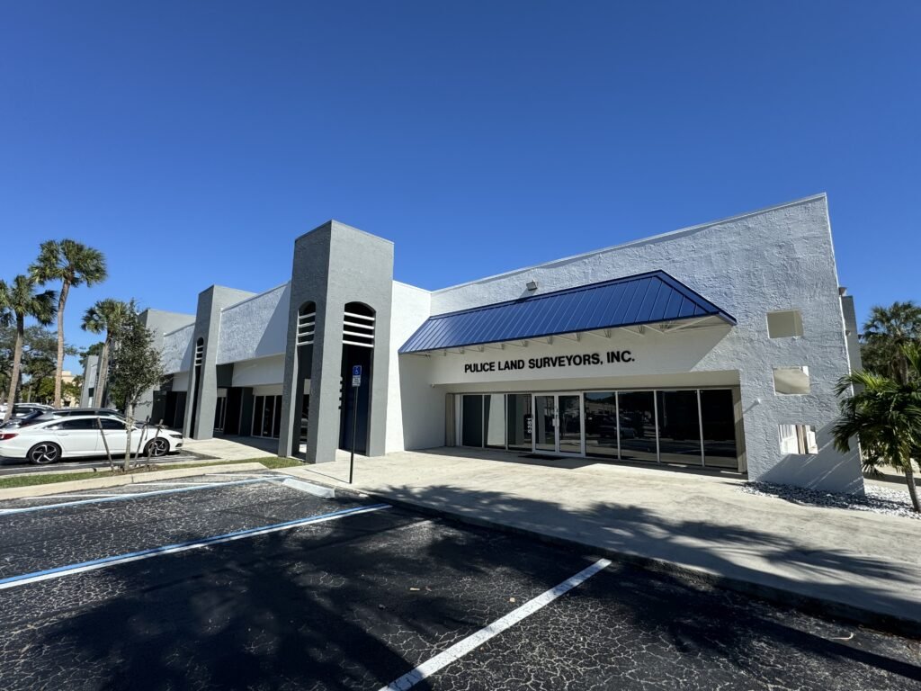 Repainted commercial office building with a blue metal roof accent